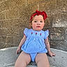 child, toddler, baby, portrait, sitting, outdoor, red_bow, blue_dress, floral_dress, brick_wall, concrete, steps, looking_at_camera, face, eyes, light_hair, rosy_cheeks, fashion, daylight, photograph
