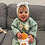 Lyna a rejoint le concours — aidez-le/la à gagner de superbes lots ! baby, child, smiling, headband, plush_toy, unicorn, couch, gray_couch, sitting, happy, indoor, cute, person, toy, colorful, clothing, face, infant, young_child, cozy