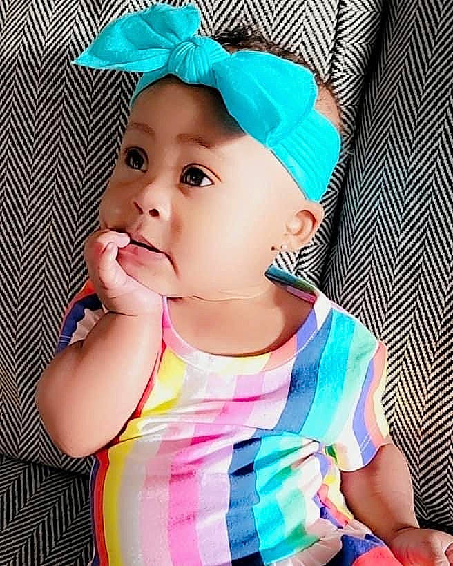 Taisley Reign is registered to the contest to win money with this photo: azure, baby, baby_toddler_clothing, blue, cap, child, clothing, costume_hat, electric_blue, eyelash, happy, hat, headwear, magenta, pattern, person, pink, skin, sleeve, t_shirt