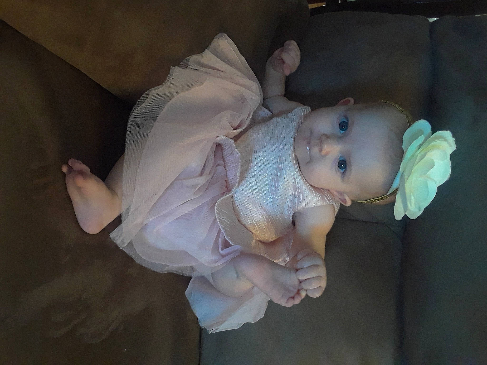 Luna is registered to the contest to win money with this photo: baby, baby_products, baby_toddler_clothing, cheek, child, cut_flowers, event, fashion_accessory, figurine, flash_photography, fun, human_body, iris, nose, person, plant, room, rose, sitting, toddler