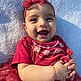 baby, baby_girl, blanket, child, closeup, clothing, cute, face, hands, happy, headband, infant, outdoor, person, portrait, red_dress, skin, smiling, sunlight, toddler