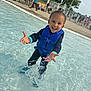 Izlan is registered to the contest to win money with this photo: child, daytime, fence, happy, leisure, life_jacket, outdoor, people, play, pool, recreation, smiling, splashing, summer, sunny, swimwear, toddler, trees, water, water_splash