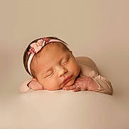 Lilah is registered to the contest to win money with this photo: arms, baby, beige_background, calm, closed_eyes, cute, flower, hands, head, headband, infant, newborn, peaceful, pink, portrait, resting, skin, sleeping, soft_lighting, studio