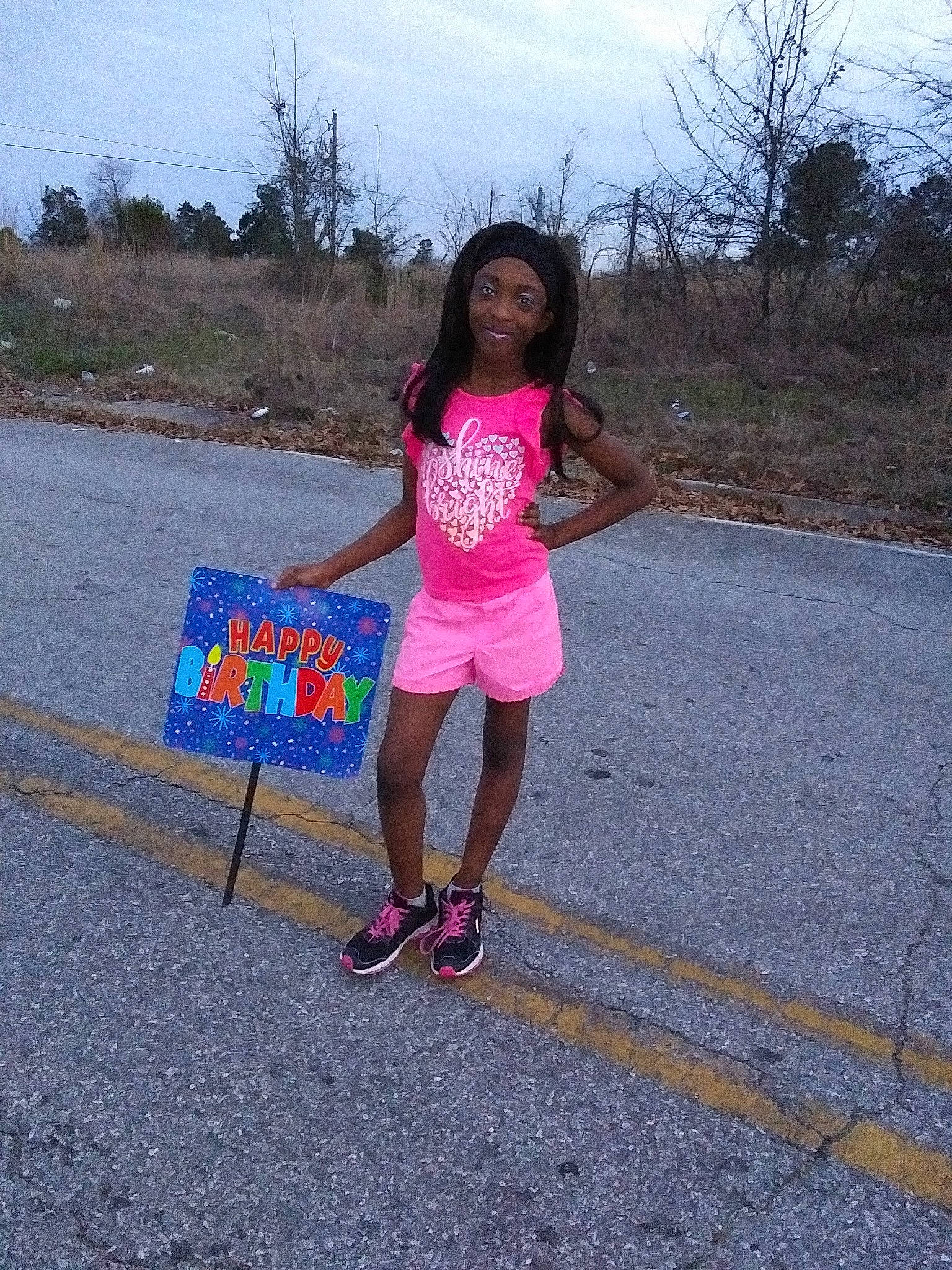 Zora is registered to the contest to win money with this photo: asphalt, electric_blue, fun, grass, headwear, human_leg, joy, leisure, magenta, pedestrian, person, pink, plant, recreation, road, road_surface, shorts, sidewalk, sky, t_shirt