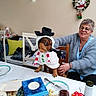 Oliver a rejoint le concours — aidez-le/la à gagner de superbes lots ! christmas, costume, cutlery, dining_table, dog, fairy_lights, festive, food, hat, holiday, humorous, indoors, person, pet, plates, portrait, snowman_costume, wine, woman, wreath