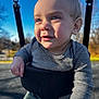 child, baby, toddler, swing, playground, outdoor, blue_sky, sunlight, portrait, closeup, striped_shirt, green_pants, smile, eyes, chubby_cheeks, chain, seat, bokeh, shadow, happy