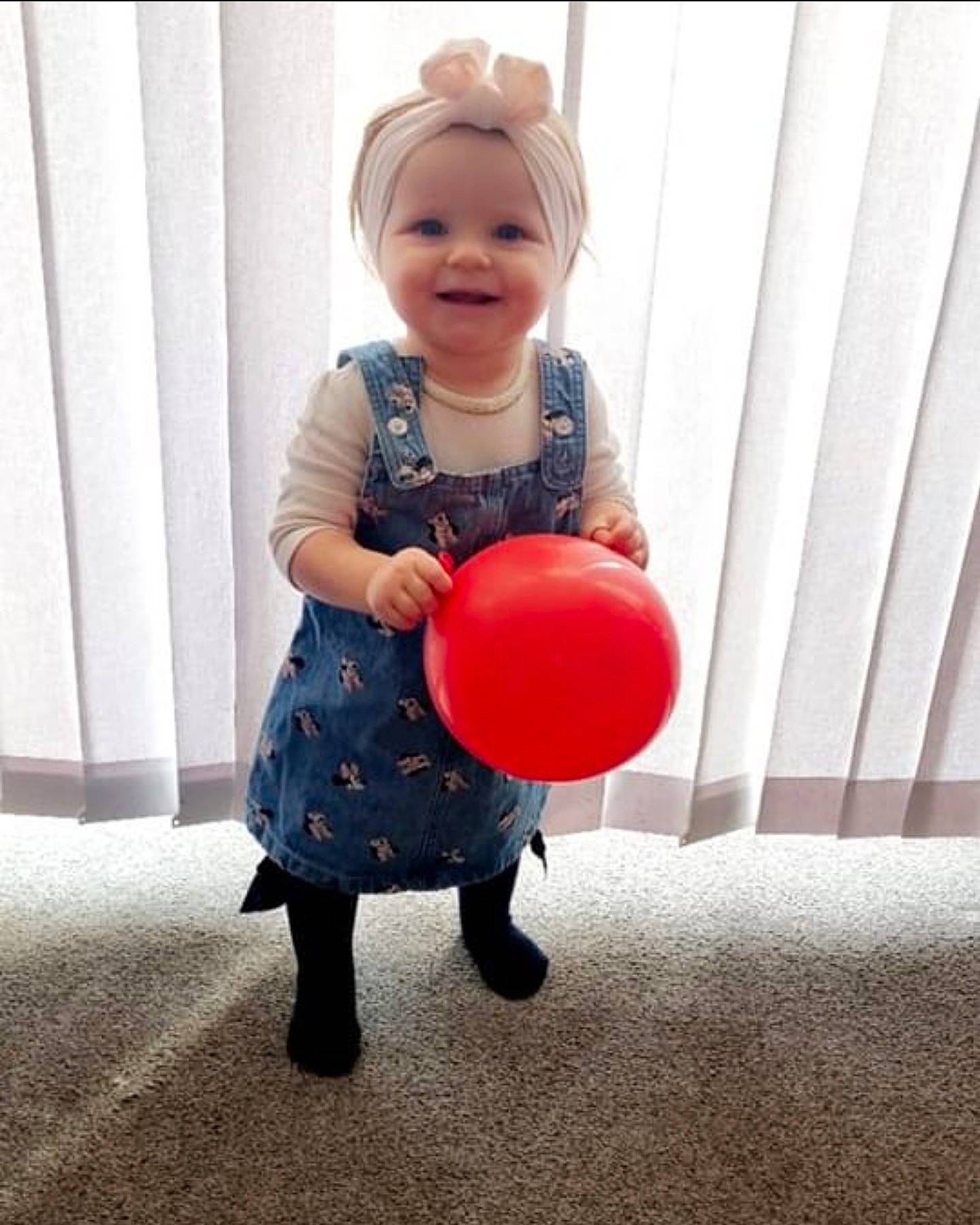 Bethany is registered to the contest to win money with this photo: arm, baby, baby_toddler_clothing, balloon, child, dress, face, fun, happy, human_body, human_leg, jeans, joy, knee, magenta, party_supply, person, sleeve, smile, t_shirt