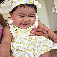 Mariko Kaimo joined the competition — help win amazing prizes! baby, child, smiling, headband, dress, pattern, yellow, white, hand, indoor, person, cute, happy, skin, face, cheeks, holding, infant, clothing, toddler