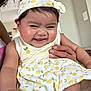 baby, child, smiling, headband, dress, pattern, yellow, white, hand, indoor, person, cute, happy, skin, face, cheeks, holding, infant, clothing, toddler