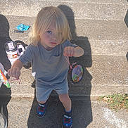 Anubis joined the competition — help win amazing prizes! child, blonde_hair, concrete, steps, shadow, crafts, holding, outdoor, sunny, shoes, spider_man, casual_clothing, serious_expression, sidewalk, grass, toy, person, young_child, summer, playtime