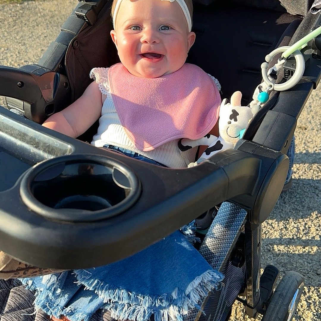 Emsley joined the competition — help win amazing prizes! accessories, baby, cap, clothing, e_scooter, face, grass, gun, hat, head, machine, outdoors, person, photography, plant, portrait, stroller, sunglasses, weapon, wheel