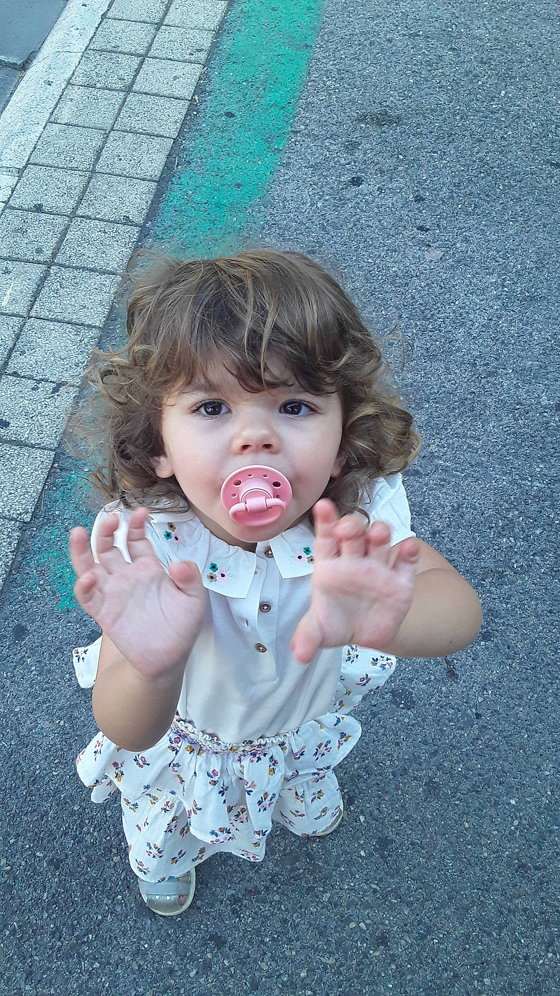 Nina participe au concours pour gagner de l'argent avec cette photo : arm, baby_toddler_clothing, chin, cool, dress, eye, facial_expression, finger, gesture, grass, hand, happy, head, iris, lip, mouth, person, pink, skin, toddler