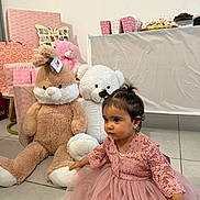Zerda Ulbeki participe au concours pour gagner de l'argent avec cette photo : child, toddler, pink_dress, stuffed_toy, teddy_bear, birthday_party, gifts, gift_wrap, plush_toy, party_decor, cake_plate, table, tile_floor, indoor, lace, tulle, sitting, portrait, hair_topknot, cute