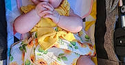 Jazmine is registered to the contest to win money with this photo: baby, baby_seat, blue_eyes, bow, child, chubby_legs, clothing, cushion, cute, face, hands, happy, indoors, infant, plush, portrait, skin, smiling, sunflower_pattern, yellow_dress