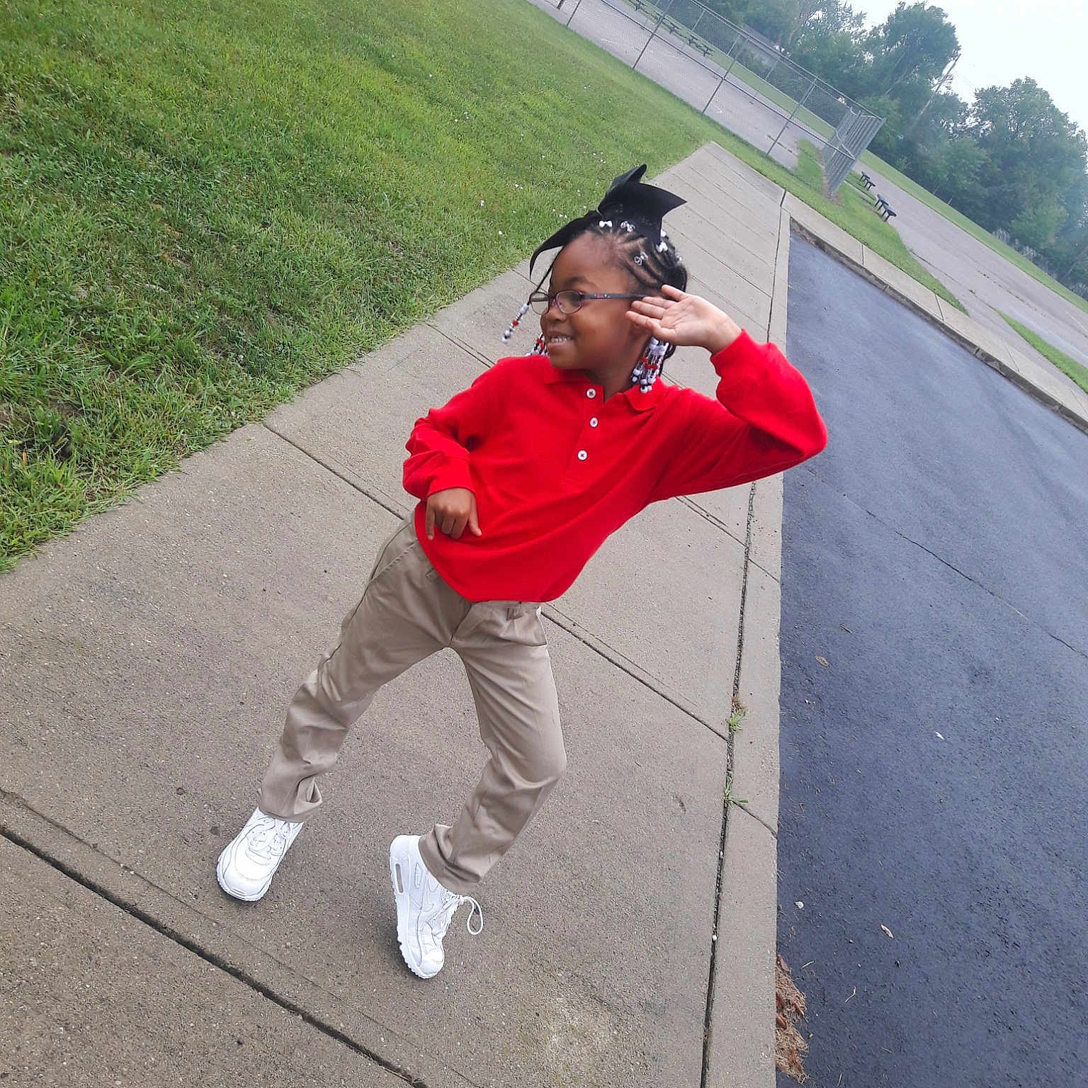 Nia is registered to the contest to win money with this photo: adventure, asphalt, cap, child, footwear, fun, headgear, leisure, person, personal_protective_equipment, plant, recreation, red, shoe, standing, vacation