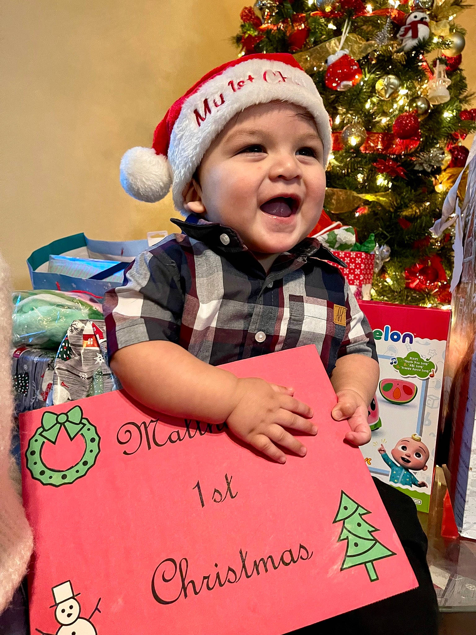 Matthew is registered to the contest to win money with this photo: baby, baby_toddler_clothing, child, christmas, christmas_decoration, christmas_eve, christmas_ornament, christmas_tree, event, facial_expression, fun, happy, headwear, holiday, holiday_ornament, pattern, person, red, sleeve, smile