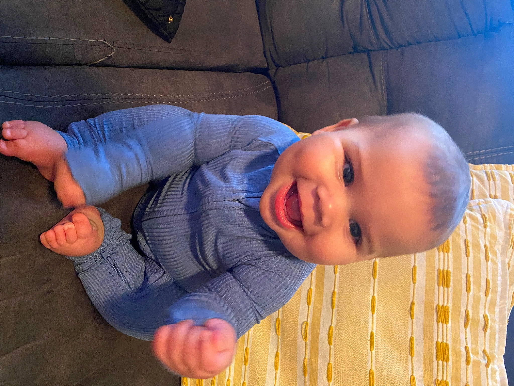 Kamden is registered to the contest to win money with this photo: baby, baby_toddler_clothing, comfort, elbow, eye, facial_expression, floor, flooring, fun, gesture, happy, human_body, joy, mouth, nose, person, skin, smile, thumb, toddler