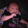 Elric joined the competition — help win amazing prizes! baby, infant, clothing, black_shirt, text, hand, face, blanket, pattern, lying_down, indoor, portrait, young_child, cute, apparel, person, night, expression, sleepwear, newborn