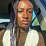 accessory, bow, braids, car_interior, casual, clothing, expressionless, face, fashion, hair, necklace, person, portrait, seat, seatbelt, sunlight, sweater, vest, window, young_adult