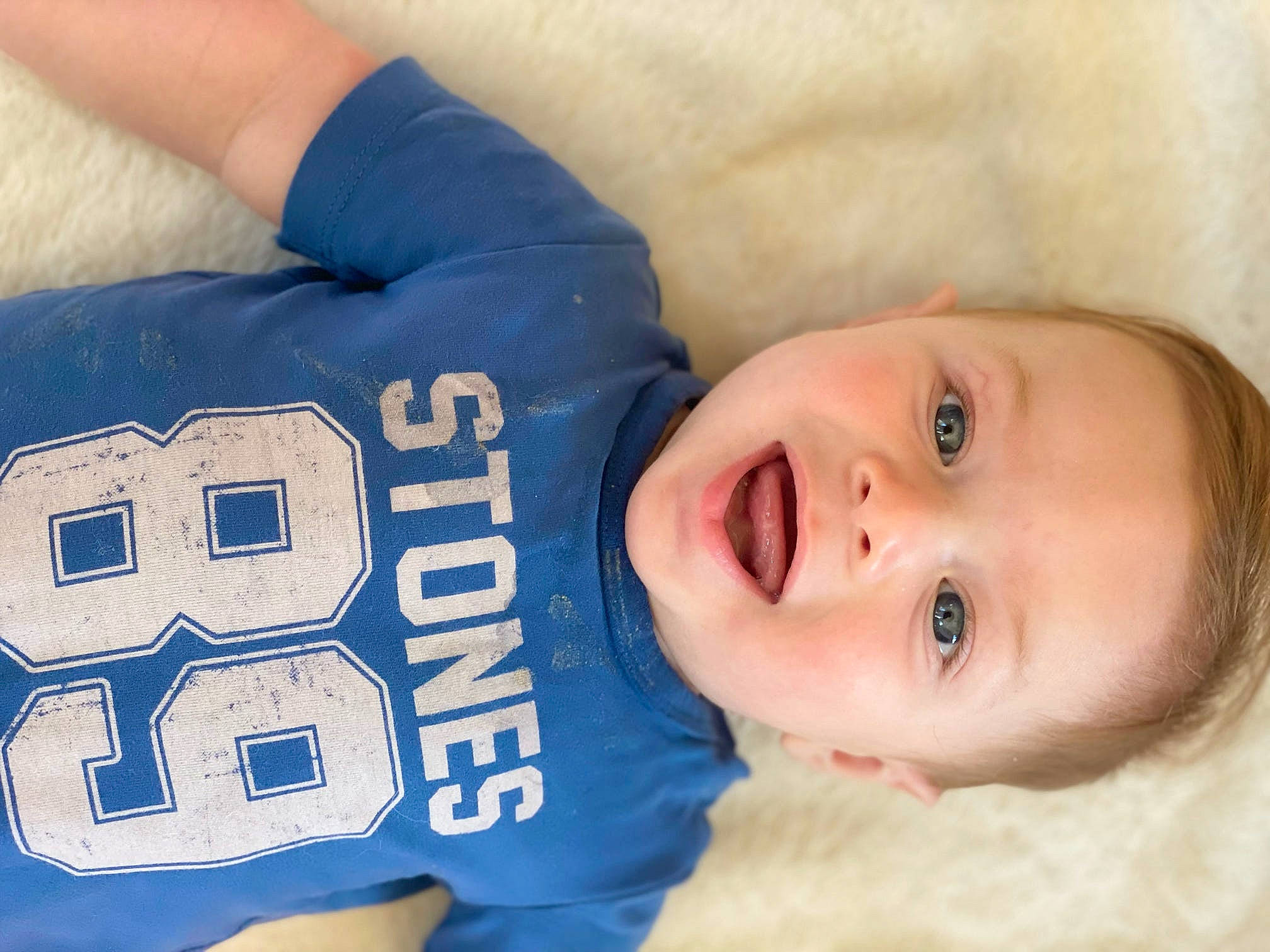 Declan joined the competition — help win amazing prizes! arm, baby, baby_toddler_clothing, cheek, comfort, electric_blue, finger, gesture, hand, happy, human_body, jersey, muscle, person, product, sleeve, smile, sports_gear, sports_uniform, textile