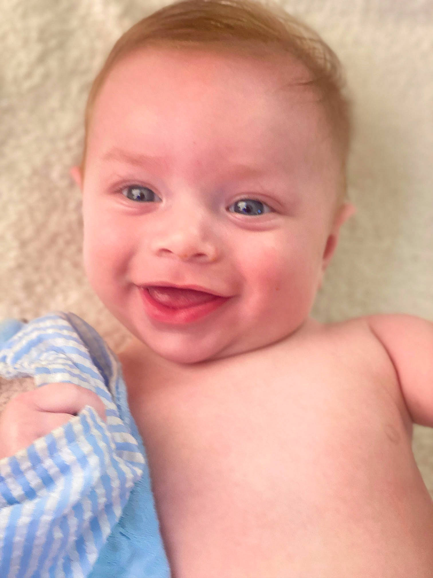 Declan is registered to the contest to win money with this photo: baby, cheek, chin, ear, eyelash, finger, gesture, happy, human_body, iris, joy, lip, mouth, muscle, neck, nose, person, skin, smile, stomach