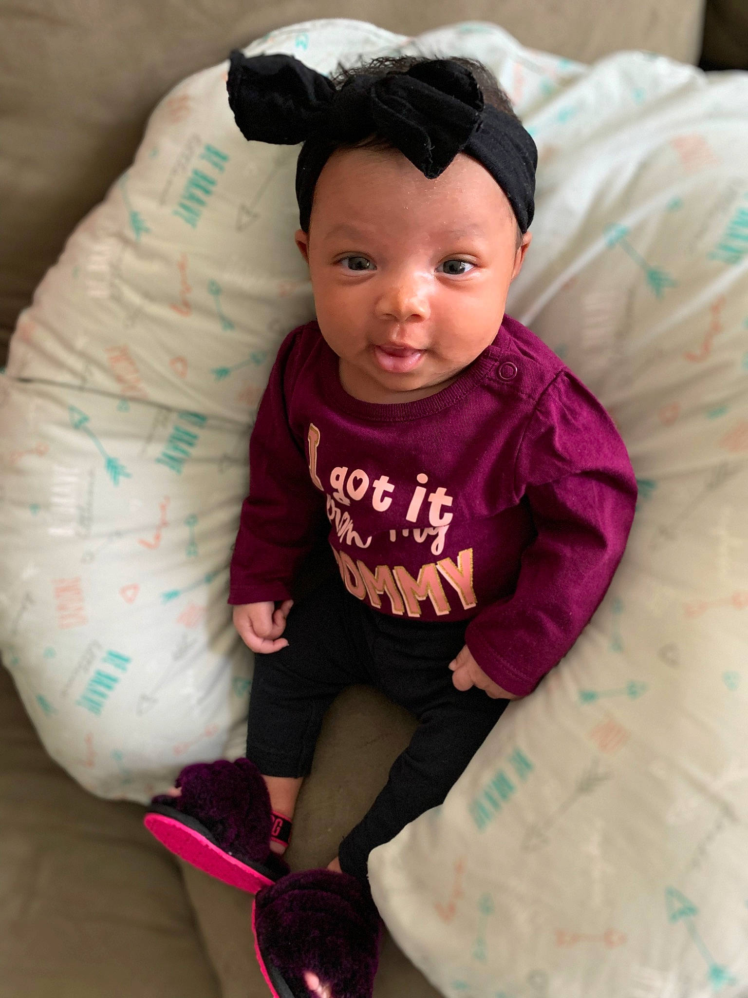 Novah is registered to the contest to win money with this photo: baby, baby_toddler_clothing, cap, cheek, child, comfort, fun, hairstyle, happy, head, linens, magenta, pattern, person, pink, sitting, skin, sleeve, smile, t_shirt