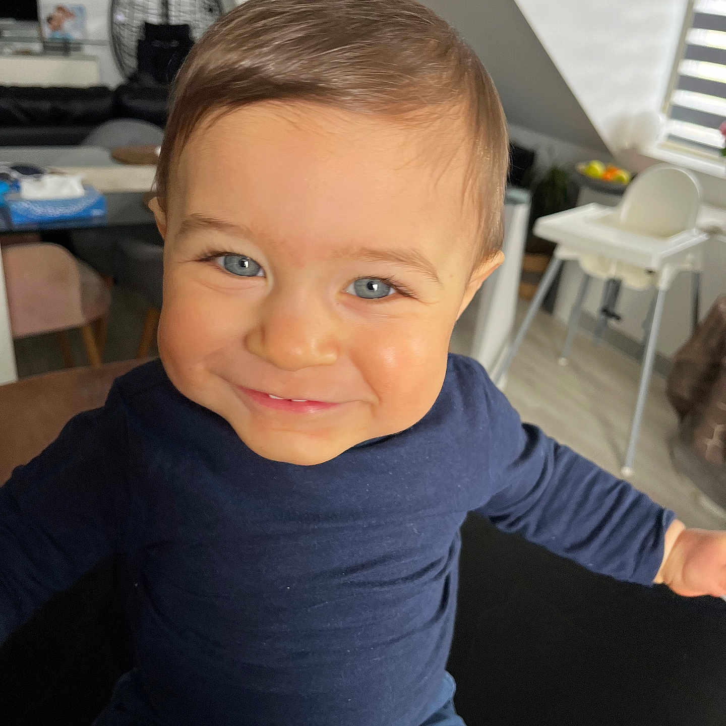 Eden participe au concours pour gagner de l'argent avec cette photo : architecture, baby, bodypart, building, clothing, couch, face, finger, furniture, hand, happy, head, longsleeve, person, photography, portrait, sleeve, smile, table, wood