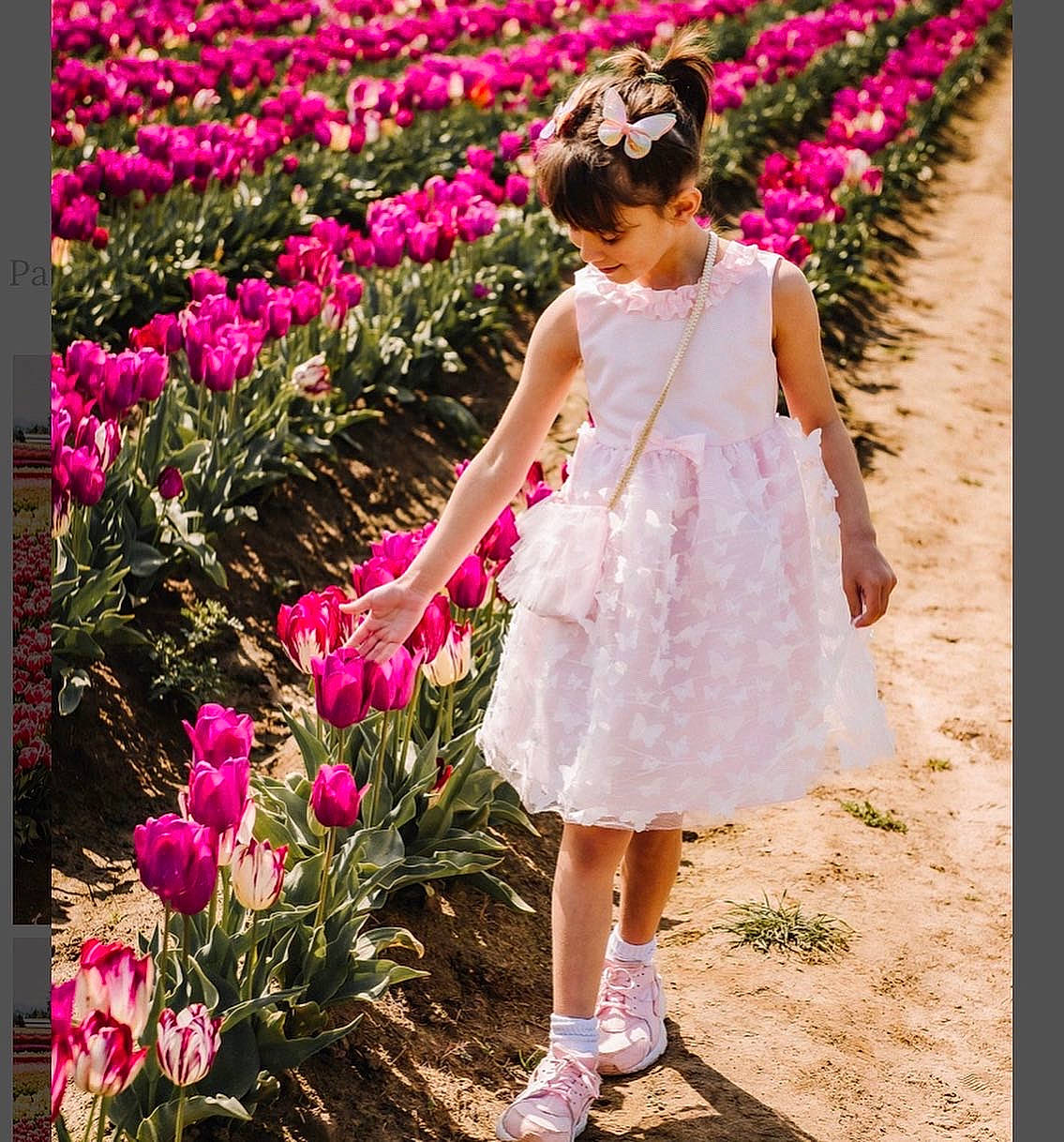 Kendall is registered to the contest to win money with this photo: botany, clothing, day_dress, dress, facial_expression, flower, flowering_plant, formal_wear, fun, grass, happy, leisure, magenta, people_in_nature, person, petal, pink, plant, street_fashion, summer