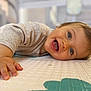 baby, child, smiling, happy, blue_eyes, face, hand, play_mat, indoor, close_up, person, infant, crawling, cute, skin, clothing, tongue, expression, young_child, toddler