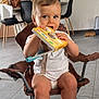 toddler, child, baby, chair, book, indoor, floor, clothing, white_shirt, feet, legs, face, expression, plant, table, modern, dining_chair, home, toy, smiling