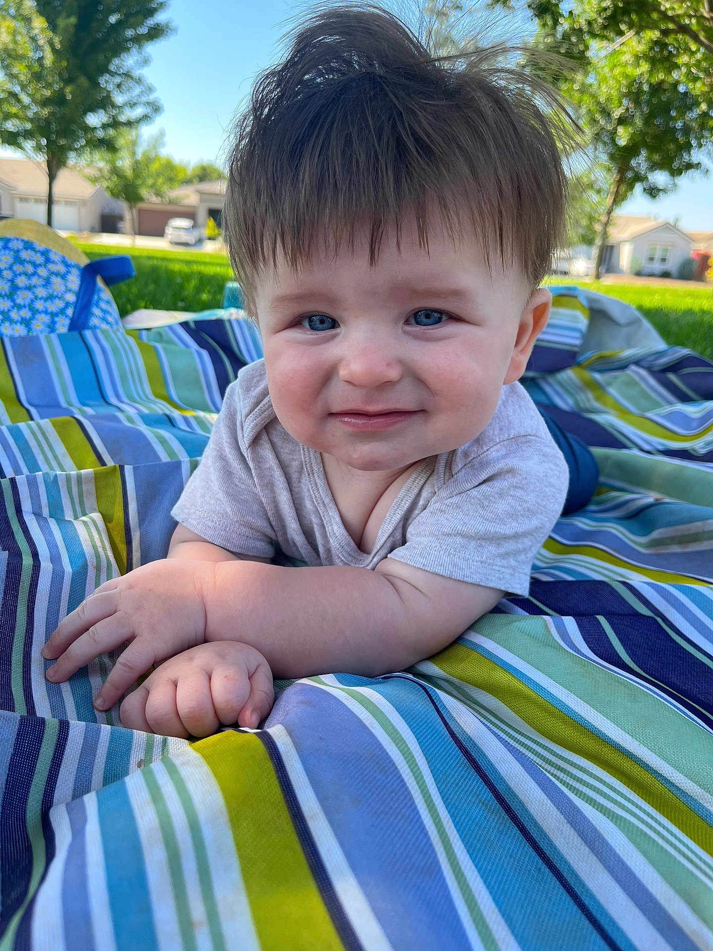 Owen joined the competition — help win amazing prizes! baby, child, blue_eyes, smile, outdoor, blanket, striped, grass, toddler, curly_hair, cute, sunny, portrait, person, nature, daylight, hand, face, clothing, neighborhood