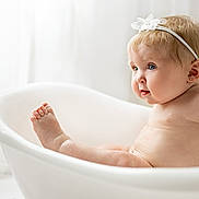 Anastasia joined the competition — help win amazing prizes! baby, bathtub, child, headband, blue_eyes, skin, cute, infant, naked, white, minimalistic, soft_light, portrait, sitting, chubby, curious, indoors, clean, tub, water_drops