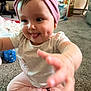 Allyanna is registered to the contest to win money with this photo: baby, child, indoor, pink_headband, dimple, tongue_out, playful, sitting, carpet, clothing, person, cute, happy, infant, toy, candid, expression, young, closeup, smile