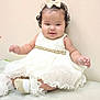 baby, child, dress, white_dress, bow, ponytail, cute, smiling, sitting, indoors, sock, baby_socks, adorable, chubby_cheeks, portrait, happy, young_child, fashion, elegant, infant
