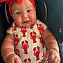baby, blue_eyes, bracelet, car_seat, child, chubby_cheeks, closeup, clothing, cute, happy, headwear, indoor, infant, lobster_print, onesie, person, plump_arms, portrait, red_headband, smiling