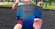 Wayln is registered to the contest to win money with this photo: baby, child, swing, playground, joy, smile, barefoot, outdoor, park, trees, grass, daylight, fun, happy, person, metal_chains, clothing, shorts, blue, green