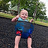 baby, child, swing, playground, park, outdoor, smiling, happy, greenery, trees, summer, casual_clothing, barefoot, metal_chains, blue_swing, grass, pavilion, recreation, fun, daytime