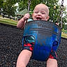 Wayln is registered to the contest to win money with this photo: baby, child, swing, playground, park, smiling, happy, foot, trees, outdoor, summer, clothing, blue, red, grass, play, fun, infant, person, daytime