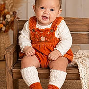 Evangelyna joined the competition — help win amazing prizes! baby, child, infant, portrait, sitting, smiling, happy, orange_outfit, overalls, wooden_chair, booties, white_socks, blanket, autumn_decor, flowers, indoor, cozy, carpet, fashion, photography