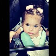Malani joined the competition — help win amazing prizes! toddler, child, baby, stroller, hair_bows, blue_eyes, face, portrait, seat, clothing, sitting, cute, curious, indoor, person, head, accessory, baby_carrier, pink, young