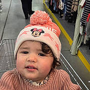 Tasnim participe au concours pour gagner de l'argent avec cette photo : aisle, background, cart, child, clothing, curly_hair, floor, hat, indoor, metal, person, pink, retail, shopping, shopping_cart, store, sweater, toddler, toys, woman