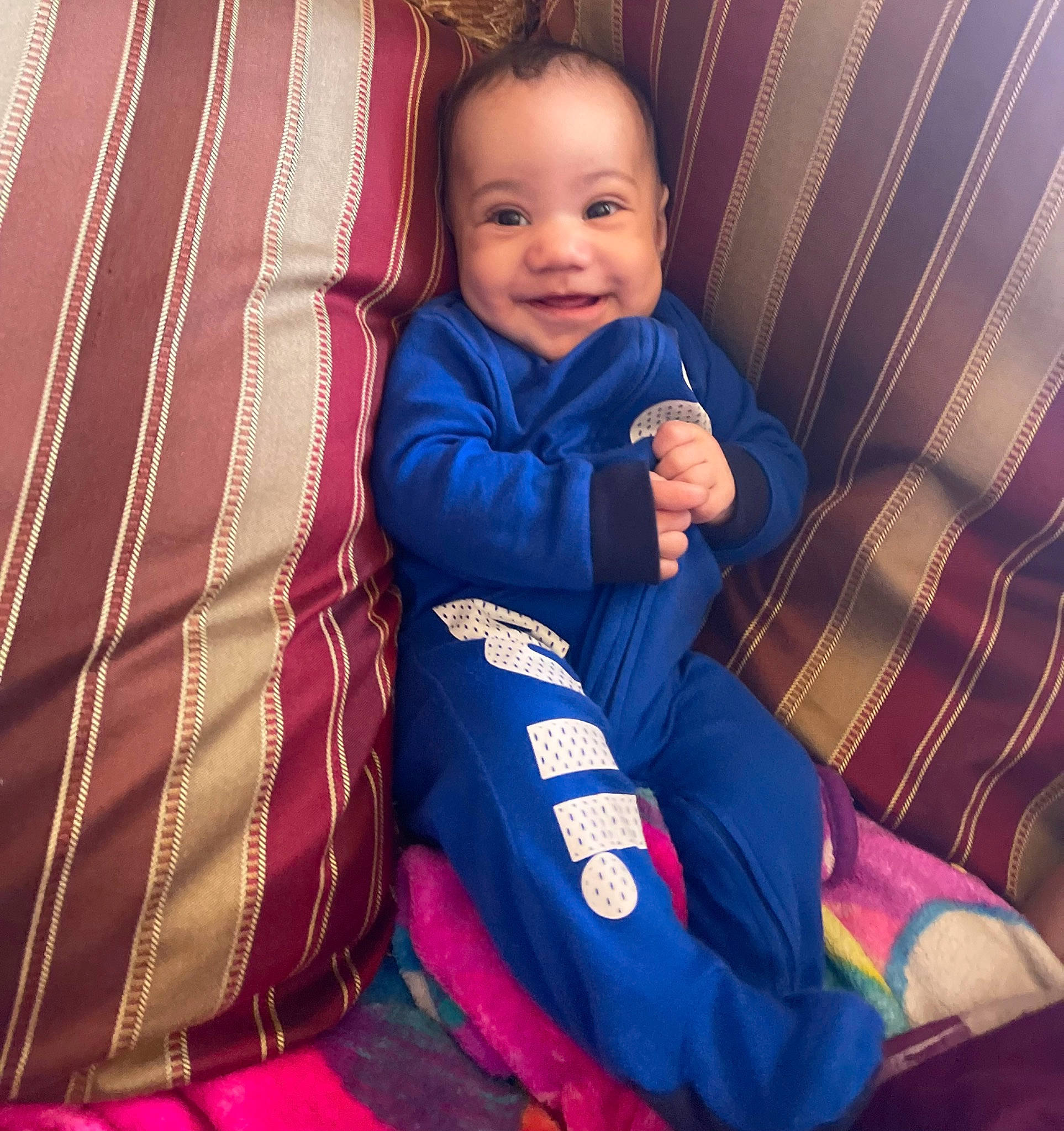 Bryson is registered to the contest to win money with this photo: baby, baby_toddler_clothing, blue, child, comfort, electric_blue, eye, face, finger, fun, happy, joy, magenta, person, purple, sleeve, smile, t_shirt, textile, thumb