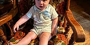 Joshua Jr joined the competition — help win amazing prizes! baby, child, chair, wooden_chair, floral_pattern, vintage, indoors, curious, expression, hair, wild_hair, sitting, foot, armrest, wood_floor, lighting, portrait, person, clothing, cute