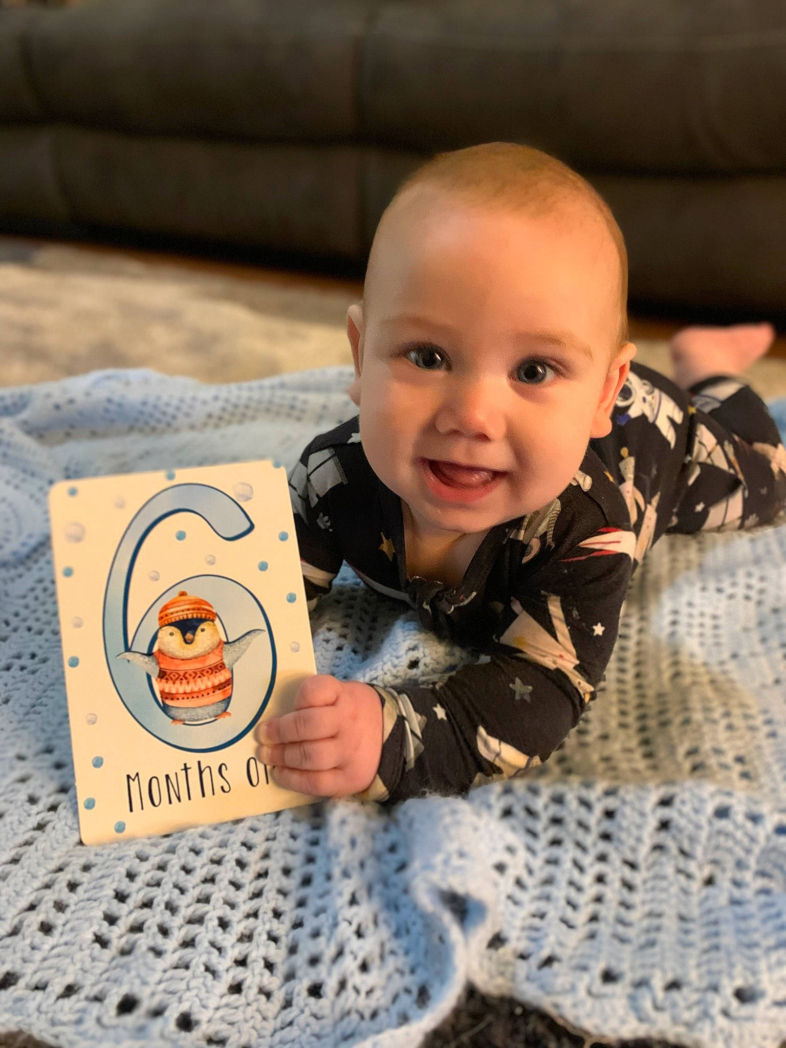 Reid joined the competition — help win amazing prizes! baby, baby_toddler_clothing, cheek, child, comfort, flooring, fun, happy, linens, mammal, nose, pattern, person, room, sitting, skin, smile, textile, toddler, vertebrate