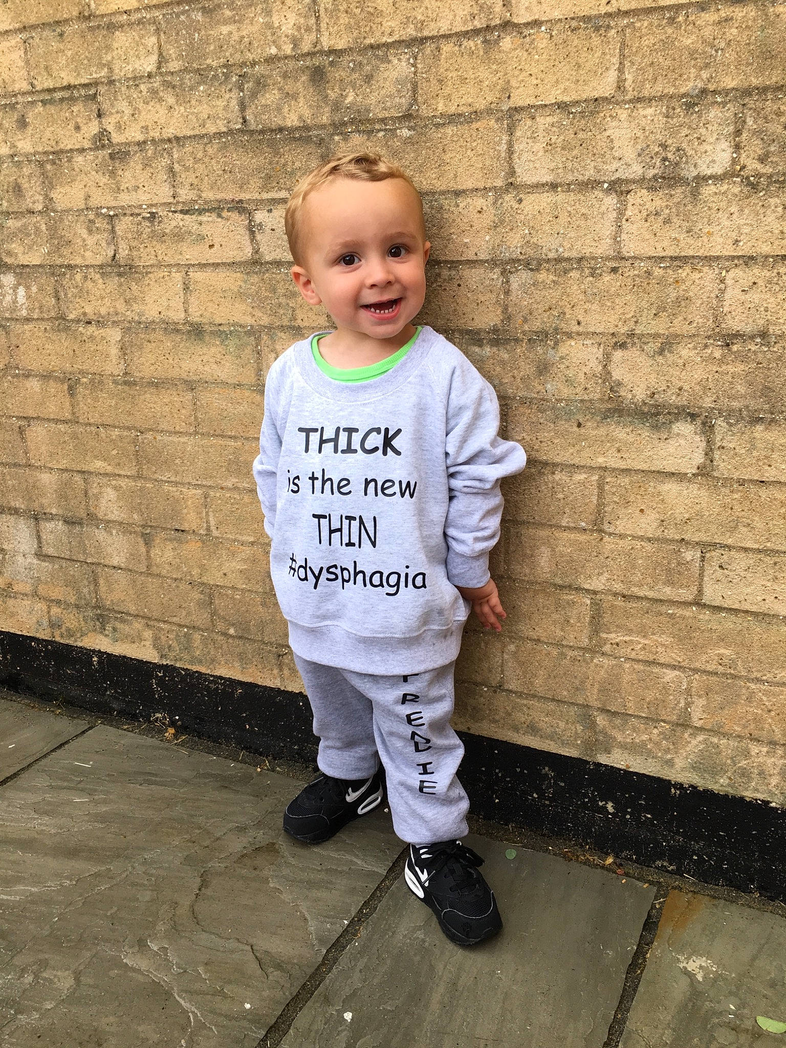 Fred is registered to the contest to win money with this photo: baby_toddler_clothing, child, joy, outerwear, person, shoe, sleeve, standing, t_shirt, toddler