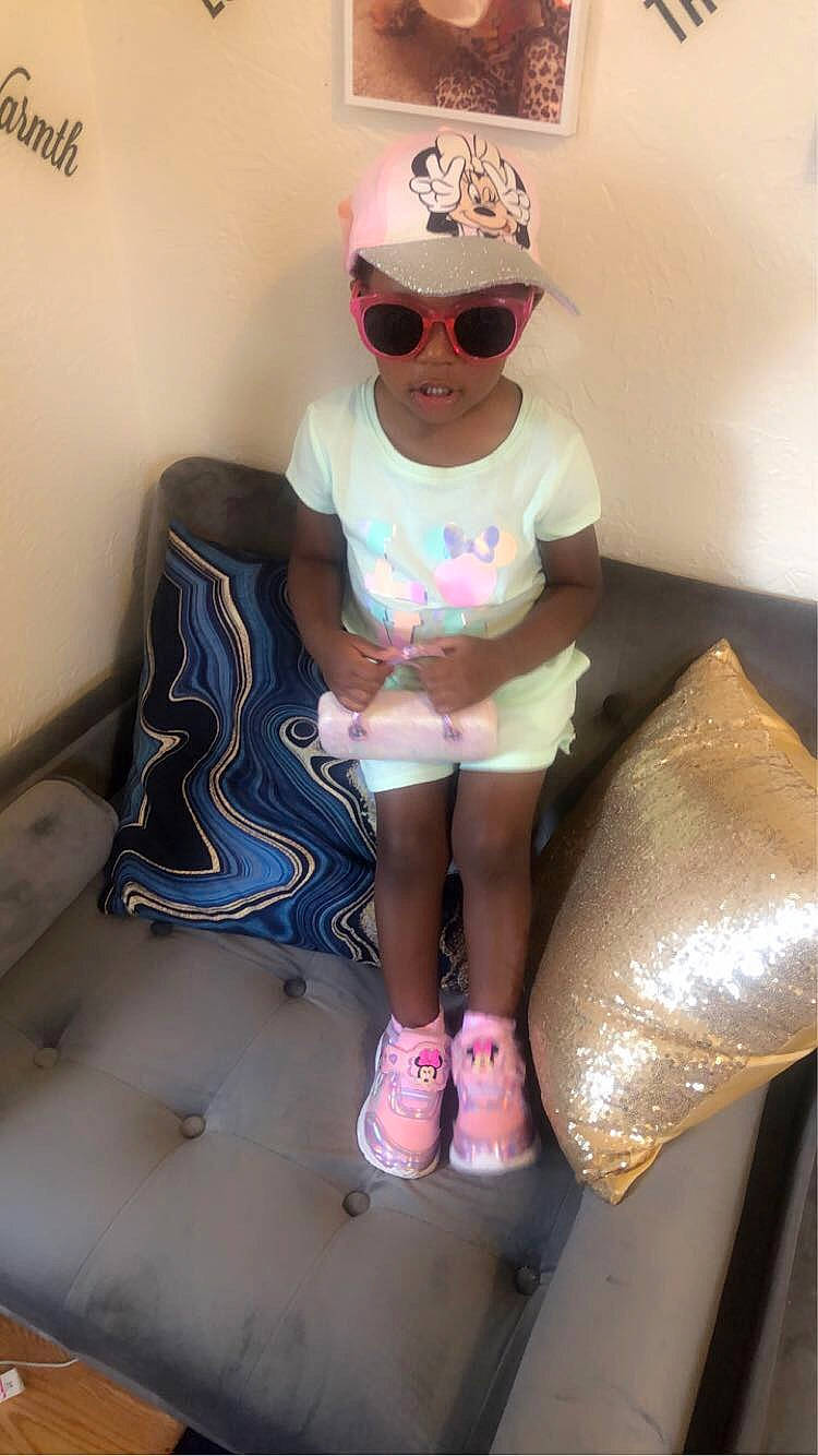 Paityn joined the competition — help win amazing prizes! baby_toddler_clothing, cap, eyewear, floor, glasses, goggles, hat, headwear, human_body, knee, leg, person, pink, shorts, sleeve, smile, sneakers, sock, sunglasses, thigh