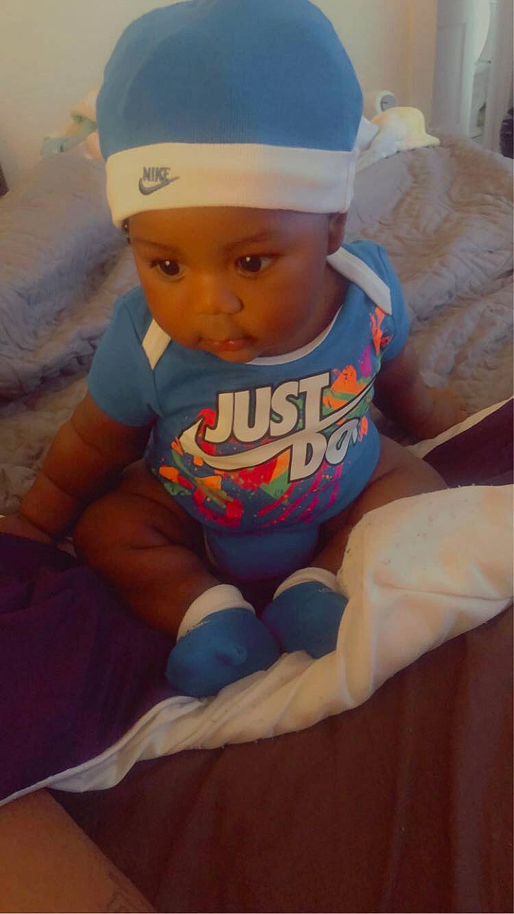 Patrick Smith Jr is registered to the contest to win money with this photo: abdomen, arm, baby, baby_toddler_clothing, baseball_cap, cap, chest, chin, comfort, eye, face, headgear, headwear, knee, neck, person, sleeve, sports_gear, t_shirt, thigh