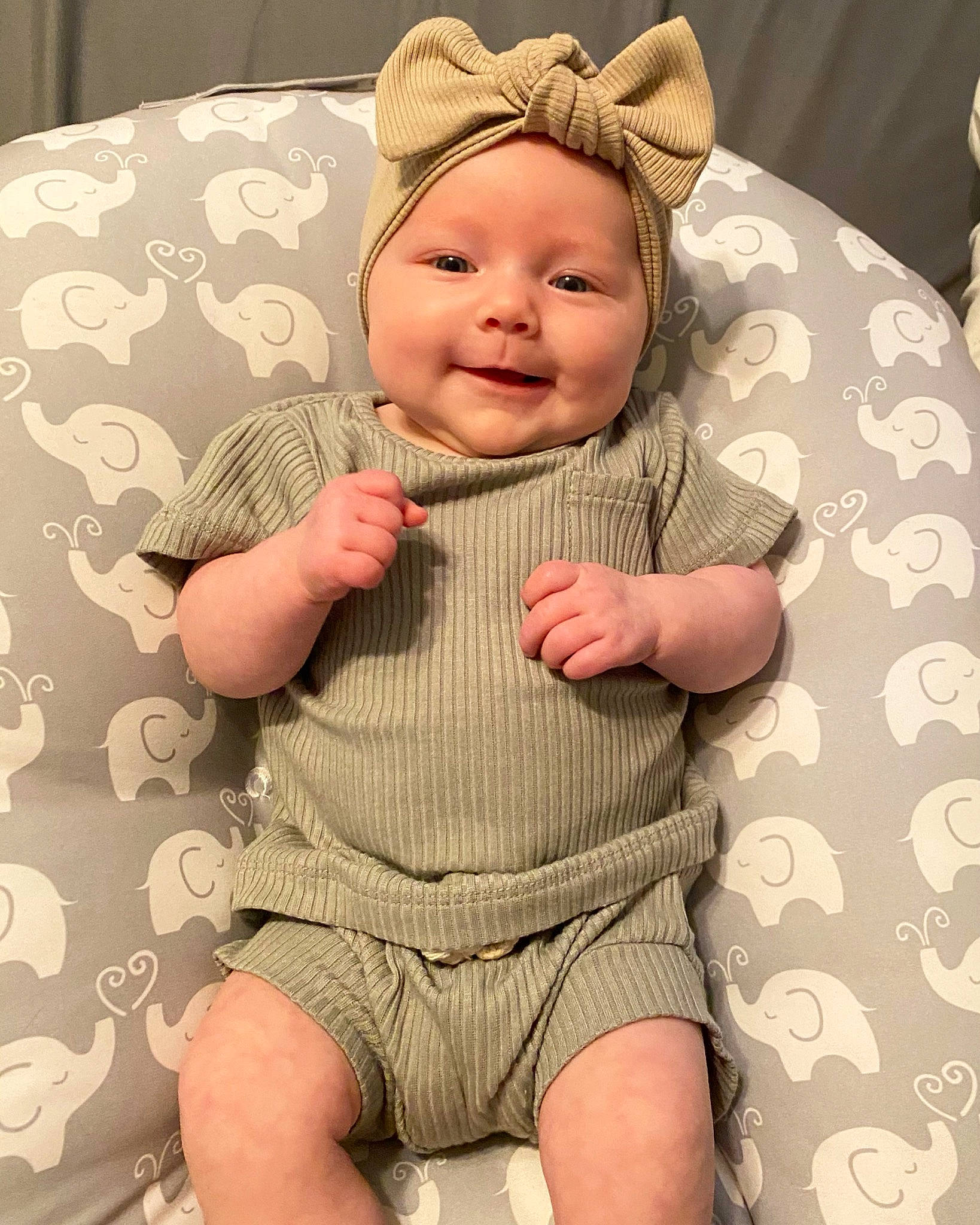 Bryer is registered to the contest to win money with this photo: baby, baby_toddler_clothing, cap, cheek, child, comfort, costume_hat, face, finger, happy, head, headwear, human_body, joy, pattern, person, pink, skin, sleeve, smile