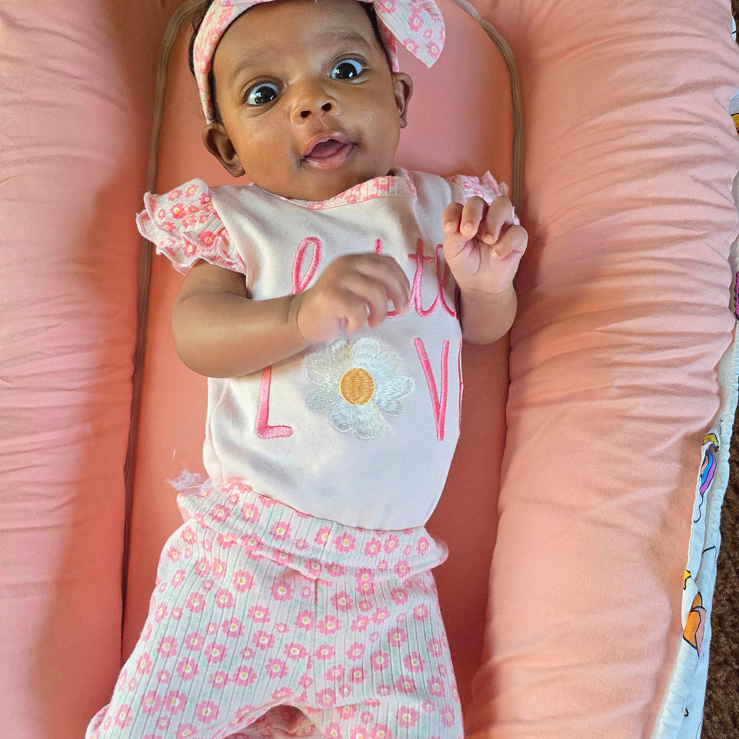 Emerald-Marie joined the competition — help win amazing prizes! adorable, baby, child, clothing, comfort, cushion, cute, expression, feet, floral_pattern, hand, headband, indoors, infant, lying_down, person, pink, portrait, soft, young