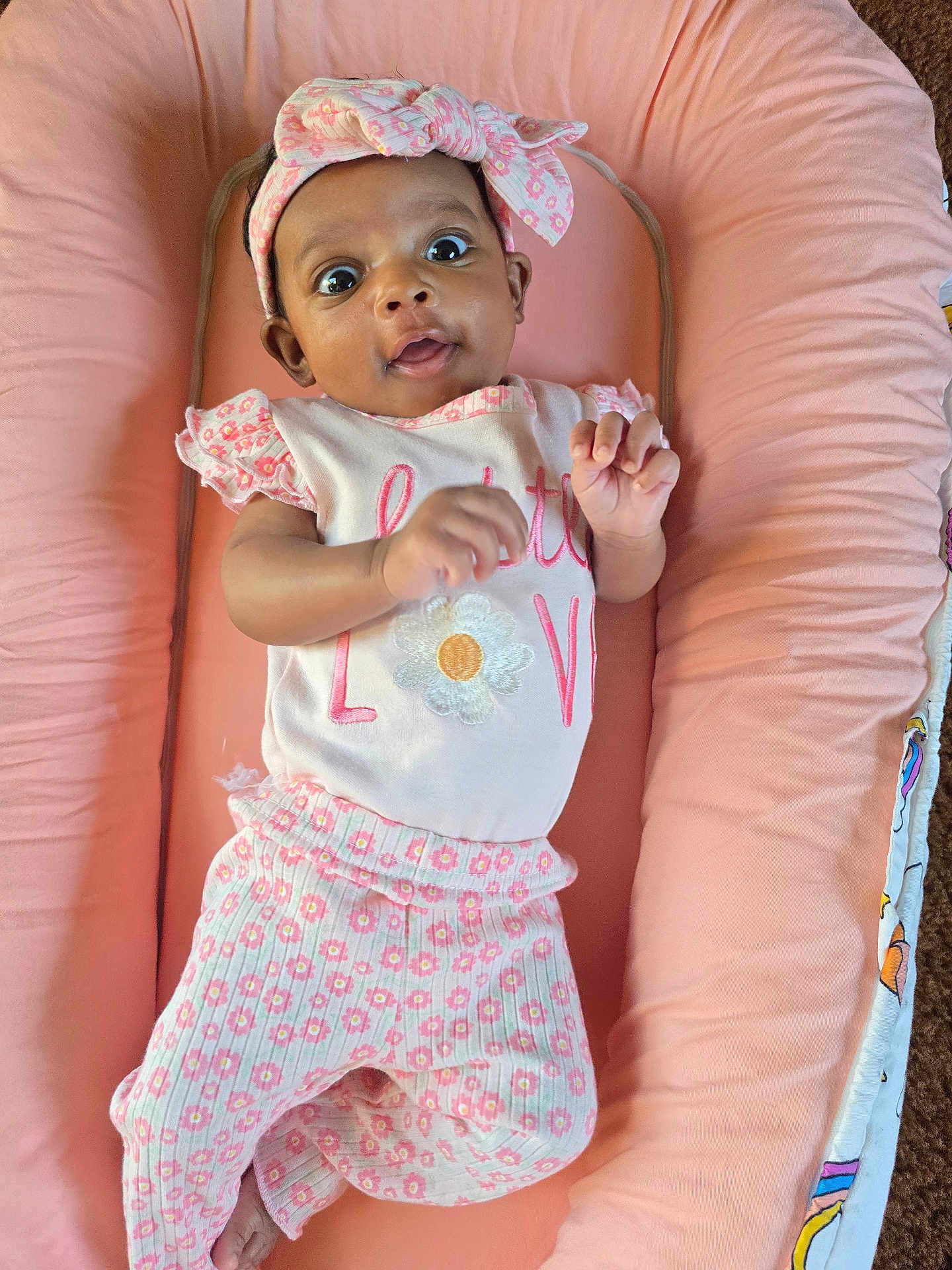 Emerald-Marie joined the competition — help win amazing prizes! baby, infant, child, pink, headband, floral_pattern, clothing, cute, lying_down, cushion, soft, indoors, portrait, expression, hand, feet, comfort, adorable, person, young